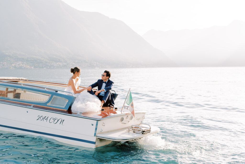 Wedding couple in golden hour on a classic boat at Lake Como