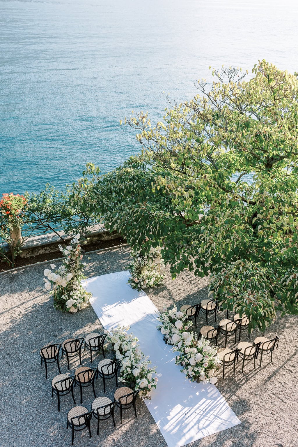 Outdoor wedding ceremony setup with floral arch at Villa Pizzo in Lake Como