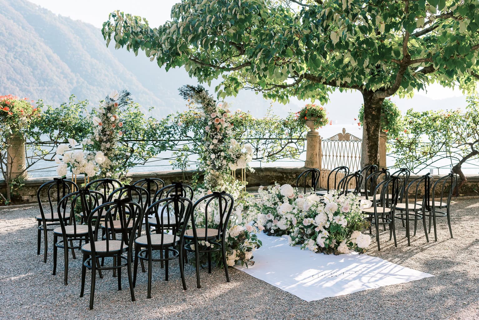 Outdoor wedding reception details, bows tied on ceremony chairs at Villa Pizzo, Lake Como