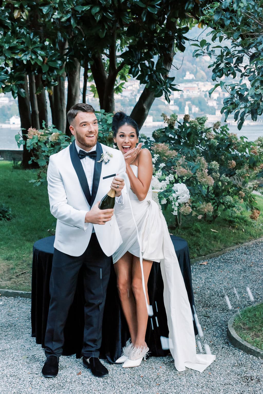 Champagne toast during reception at Villa Pizzo wedding inspiration with Lake Como in the background